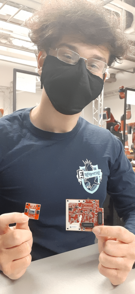 Brandon Gonzalez holding two sensor chips.