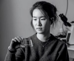 Jina Ko looking at a slide.